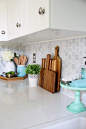 Kitchen accessories, cutting boards, Carra marble backsplash. Beautiful white IKEA SEKTION GRIMSLOV kitchen with aqua and green accents, a gorgeous marble hexagon backsplash, and quartz countertops. | JustAGirlAndHerBlog.com: 