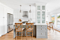Example of a mid-sized cottage l-shaped medium tone wood floor and brown floor eat-in kitchen design in Vancouver with an undermount sink, shaker cabinets, gray cabinets, quartz countertops, white backsplash, subway tile backsplash, stainless steel applia