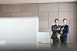 Portrait confident businessman and businesswoman in conference room by Caia Images on 500px