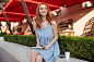 Free photo smiling redhead girl in earphones making notes in notepad