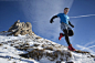 Caucasian man running on snowy mountain - stock photo