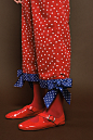 Red trousers printed with white polka dots and blue bottom.