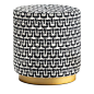 Sitting atop a round base displaying a marvelous wooden base with a brushed bronze finish effect, this exquisite cylindrical pouf boasts a seat upholstered in an intriguing "Marilù" fabric characterized by a timeless, geometrical, black and whit