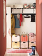 Red mudroom with rolling storage crates and shaker peg coat hooks. Love the patterned boxes! | 100+ Beautiful Mudrooms and Entryways at Remodelaholic.com