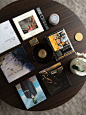 the table is covered with books, magazines and other things to read on top of it