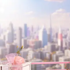 a pink box with flowers in it, in the style of grandiose cityscape views, anime inspired, glass as material, soft and dreamy atmosphere, spectacular backdrops, playful details, spatial concept
