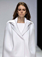 - white, armless jacket with clean silhouette, smooth lines and moulded, sculptural collar detail // Tze Goh