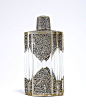 1920s Coty perfume bottle, clear glass, pierced Chinese silver mounts and screw cap. Molded Coty France. 5 in.