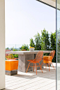 Concrete Block Outdoor Dining Table with Orange Metal Dining Chairs