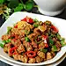 【孜然牛肉粒】1.牛肉洗净切小丁，青红椒洗净切小圈状，洋葱切小丁，生姜去皮切片，牛肉丁中加入料酒、盐、红烧酱油、孜然（粉末+颗粒）、水淀粉、香油，混合均匀，腌制20分钟；2.锅中放油加热至5成，放入腌好的牛肉粒翻炒至变色，盛出备用；3.锅中放入少许油加热，放入洋葱碎和生姜片炒至微微焦黄色，放入辣椒圈炒出香味；4.依次放入炒好的牛肉粒、孜然、辣椒粉、白芝麻翻炒均匀即可。