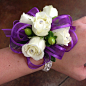 Purple ribbon, white rose wrist corsage