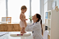 smiley-doctor-holding-baby-medium-shot_23-2149728930
