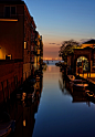 landscape photo of river with boats beside a building