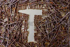 铁锤的形状在生锈的钉子之间。黄色背景