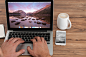 工作，办公-Man sitting in front of laptop’s screen with mountain landscape on ...