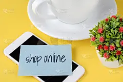 有“网上购物”文字的纸质卡片，咖啡和电话