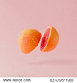 Grapefruit sliced on pastel pink background. Minimal fruit concept.