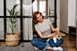 charming-woman-jeans-is-resting-living-room-playing-with-dog_197531-14792