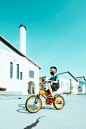 boy in black and white long sleeve shirt riding on yellow bicycle during daytime