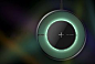 This may contain: a black and green clock hanging from a wire