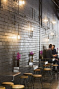 I picked this picture because I like the simplicity of the design.  The modern elements make the space feel industrial and sophisticate.  The bent metal as the table complements the colour of the wall while the warm wood stools warm up the space to balanc