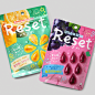 two packets of fruit are shown on a gray background, one is pink and the other is green