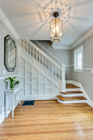 Example of a mid-sized transitional medium tone wood floor and beige floor entryway design in Chicago with gray walls and a white front door