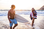 Caucasian couple walking on beach by Gable Denims on 500px