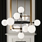 The Viaggio Chandelier by Tech Lighting is a quirky blend of industrial and mid-century modern design. Its unique silhouette features a random assortment of Glass orbs (with sleek Black sockets) which are supported by solid Metal arms that extend and bend
