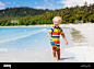 child-playing-on-tropical-beach-little-boy-digging-sand-at-sea-shore-family-summer-vacation-kids-play-with-water-and-sand-toys-ocean-and-island-fu-T16R6D