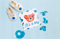 Flat lay of blue baby shower decorations with shoes