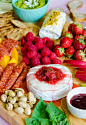 This is the ultimate cheeseboard for summertime! Cheese and herbs are coupled with summer fruits, nuts, meats, guacamole and rhubarb compote.