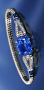 An art deco sapphire and diamond bracelet, Cartier, French, circa 1925 centering a cushion-cut sapphire, joining a slender looped line of old European and single-cut diamonds, accentuated by calibré-cut sapphires; signed Cartier Paris London New York, no.