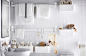Different white plastic organisers hangs with the help of suctions-cups on the a white tiled bathroom wall