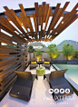 Modern Industrial seating area with a custom steel and wooden shade structure.