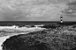 grayscale-photo-of-lighthouse-on-seashore-3063097