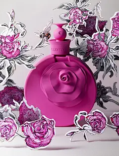 This may contain: a pink perfume bottle surrounded by cut out flowers