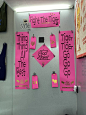 This may contain: pink signs are hanging on the wall in front of some other items that have been pinned to them