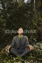 Young Businessman Sitting in Meditation by iofoto - Stock Photo