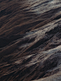 a lone sheep standing on top of a mountain