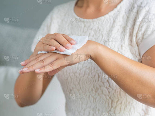 女人用纸巾擦手。医疗保健理念.