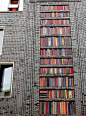 wall of books - a 10 meter high wall in Amsterdam west, designed with ceramic books / photo By andrevanb on flickr: 