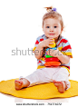 Baby playing with pyramid isolated on white