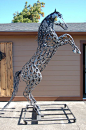 'Kaspar' - sculpted from recycled horseshoes by Bud Thomas of Oregon Horseshoe Art;  stands 9.5 feet tall;  he has a 'wilder mane and fierce stance' than 'Gabriel' (another horse sculpter by Thomas);  even the mane, tail, face and each hoof are made by he