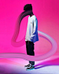 a man standing in front of a pink background with long white lines coming out of his back
