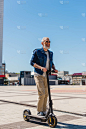 full length of cheerful man in sunglasses riding e