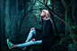 Woman Sitting on Green Tree Trunk Looking Up during Daytime