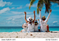 happy family with two kids hands up on the beach