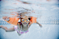 Hispanic girl swimming underwater in pool by Gable Denims on 500px