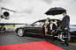 Businessman exiting limousine on airport runway